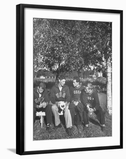 American and Russian Olympic Athletes Sitting on Bench and Talking-Ralph Crane-Framed Premium Photographic Print