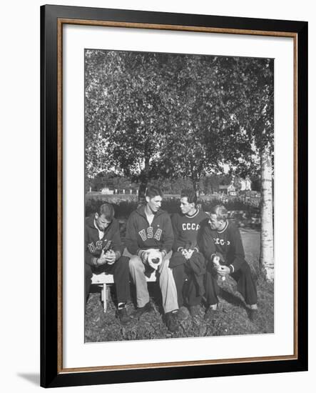 American and Russian Olympic Athletes Sitting on Bench and Talking-Ralph Crane-Framed Premium Photographic Print