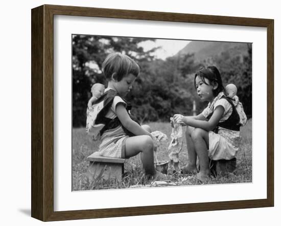 American Child Playing with Chinese Friend, Washing Doll Clothes-John Dominis-Framed Photographic Print