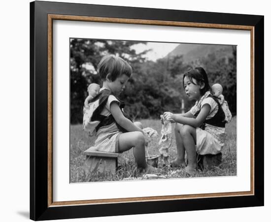 American Child Playing with Chinese Friend, Washing Doll Clothes-John Dominis-Framed Photographic Print