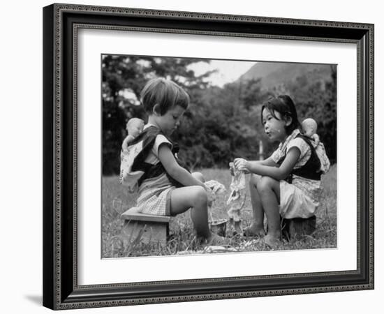 American Child Playing with Chinese Friend, Washing Doll Clothes-John Dominis-Framed Photographic Print