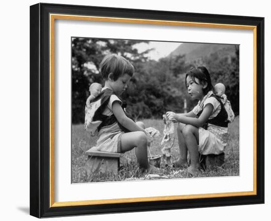 American Child Playing with Chinese Friend, Washing Doll Clothes-John Dominis-Framed Photographic Print