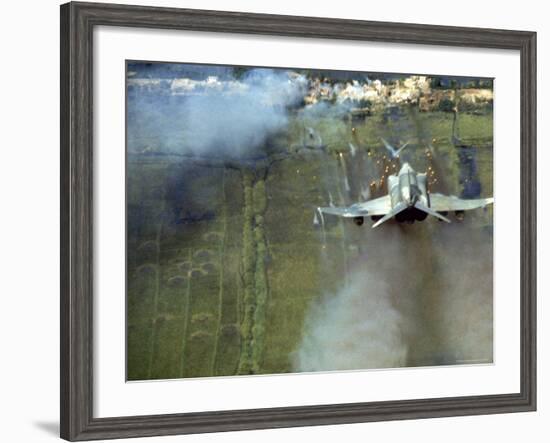 American F4C Phantom Jet Firing Rockets into Viet Cong Stronghold village During the Vietnam War-Larry Burrows-Framed Photographic Print