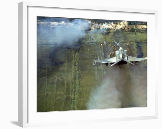 American F4C Phantom Jet Firing Rockets into Viet Cong Stronghold village During the Vietnam War-Larry Burrows-Framed Photographic Print