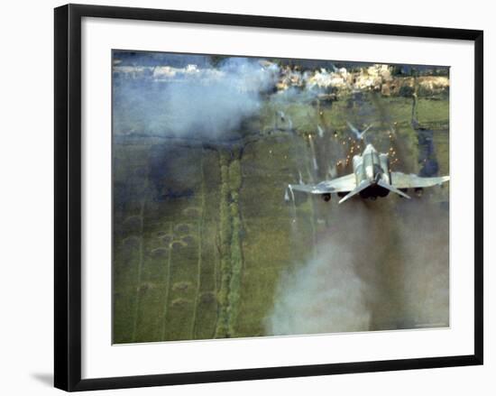 American F4C Phantom Jet Firing Rockets into Viet Cong Stronghold village During the Vietnam War-Larry Burrows-Framed Photographic Print