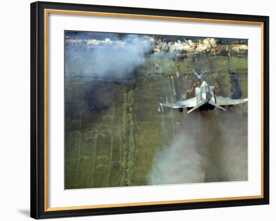 American F4C Phantom Jet Firing Rockets into Viet Cong Stronghold village During the Vietnam War-Larry Burrows-Framed Photographic Print