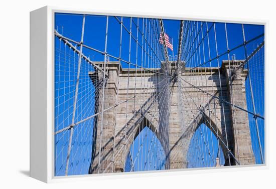 American flag flying over Brooklyn Bridge, New York City, New York-null-Framed Premier Image Canvas