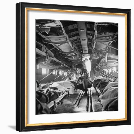 American "Flying Nurse", Julia Corinne Riley, Checks on Patients Aboard C-47 Transport Plane-Eliot Elisofon-Framed Photographic Print