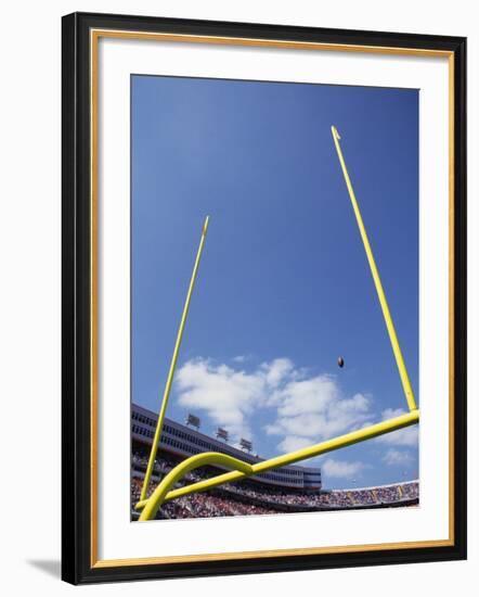 American Fooball Flying Through the Goalposts-null-Framed Photographic Print