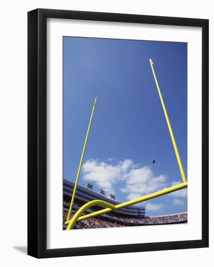 American Fooball Flying Through the Goalposts-null-Framed Photographic Print