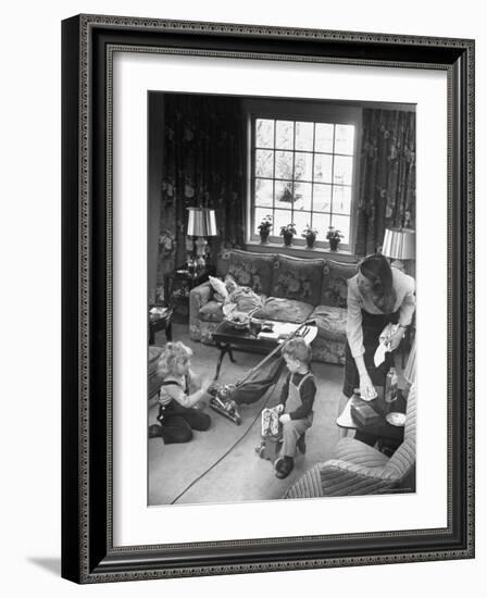 American Housewife Marjorie McWeeney Cleaning House and Watching Her Children-Nina Leen-Framed Photographic Print