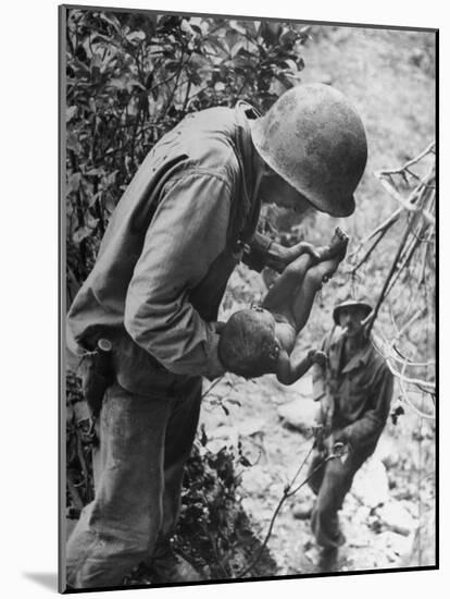 American Lieutenant Carrying Micronesian Baby He Found in cave Japanese Soldiers Holed Up There-W^ Eugene Smith-Mounted Photographic Print