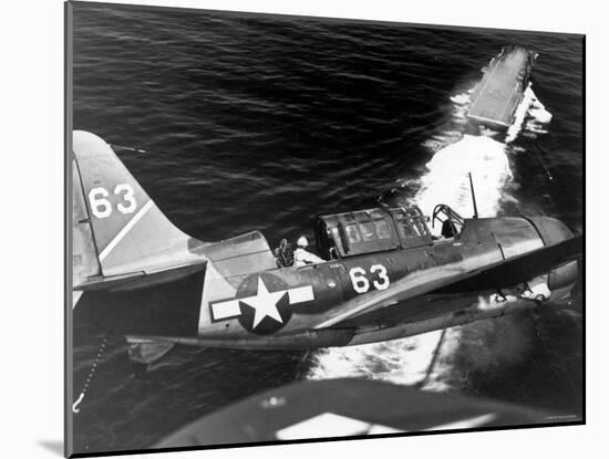 American SB2C Scout Plane Circling Above an Aircraft Carrier Prior to Landing-null-Mounted Photographic Print