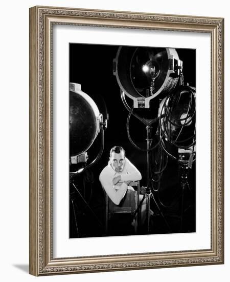 American silent screen comedian and actor Buster Keaton (1895 - 1966) surrounded by studio lighting-null-Framed Photo