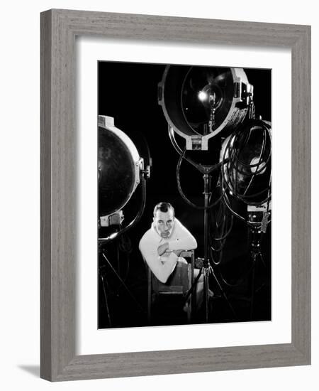 American silent screen comedian and actor Buster Keaton (1895 - 1966) surrounded by studio lighting-null-Framed Photo