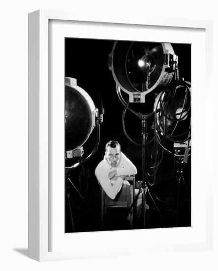 American silent screen comedian and actor Buster Keaton (1895 - 1966) surrounded by studio lighting-null-Framed Photo