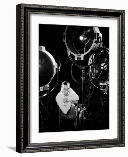 American silent screen comedian and actor Buster Keaton (1895 - 1966) surrounded by studio lighting-null-Framed Photo