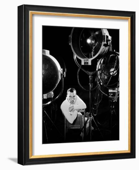 American silent screen comedian and actor Buster Keaton (1895 - 1966) surrounded by studio lighting-null-Framed Photo