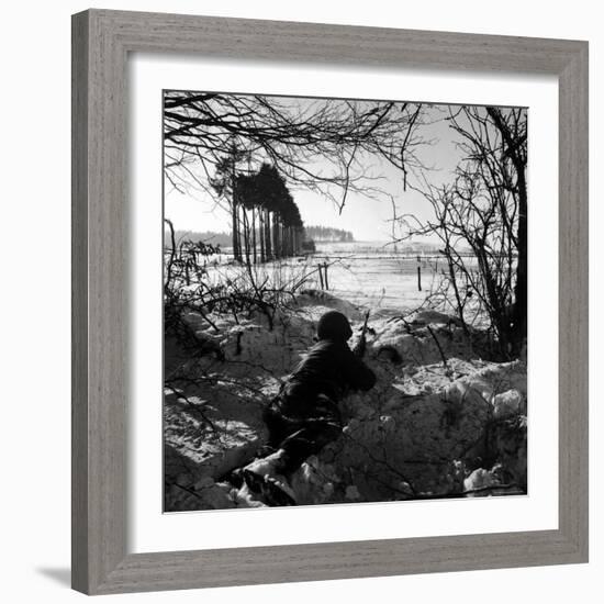 American Soldier Peering Across Snowy Field During Counter Offensive Known as Battle of the Bulge-John Florea-Framed Photographic Print