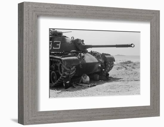 American soldier reads a newspaper in the shade under a U.S. Marine tank in Beirut, Lebanon, 1958-Thomas J. O'halloran-Framed Photographic Print