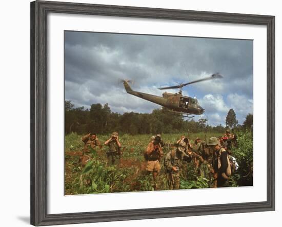 American UH1 Huey Helicopter Lifting Off as Personnel on the Ground Protect Themselves-Larry Burrows-Framed Photographic Print