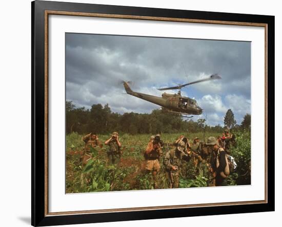 American UH1 Huey Helicopter Lifting Off as Personnel on the Ground Protect Themselves-Larry Burrows-Framed Photographic Print