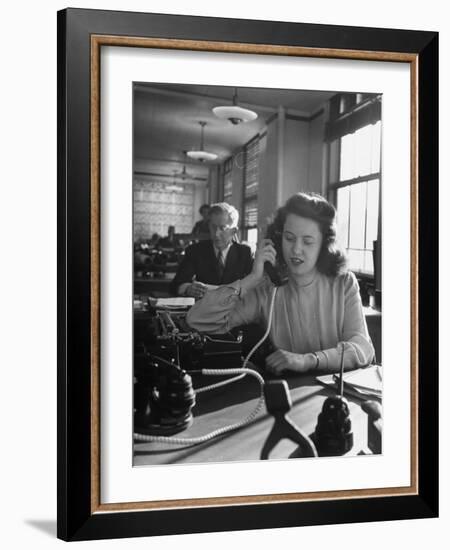 American Working Woman Sitting at Her Typewriter and Talking on the Telephone-Nina Leen-Framed Photographic Print