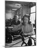 American Working Woman Sitting at Her Typewriter and Talking on the Telephone-Nina Leen-Mounted Photographic Print