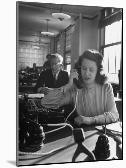 American Working Woman Sitting at Her Typewriter and Talking on the Telephone-Nina Leen-Mounted Photographic Print