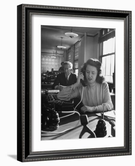 American Working Woman Sitting at Her Typewriter and Talking on the Telephone-Nina Leen-Framed Photographic Print