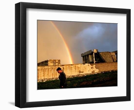 An Afghan Man Walks Past Destroyed Buildings Occupied by Refugees after a Heavy Rain-null-Framed Photographic Print