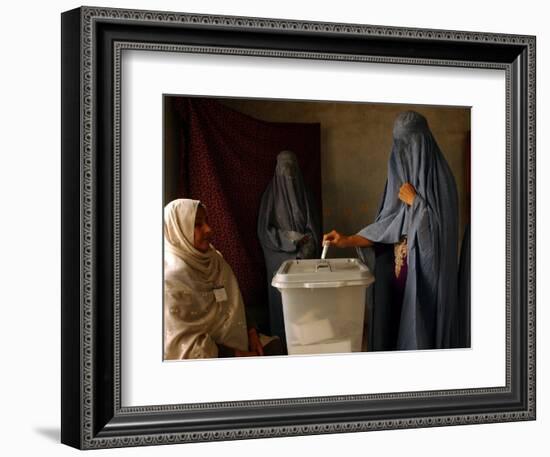 An Afghan Woman Wearing a Burqa Casts Her Ballot at a Polling Station-null-Framed Photographic Print