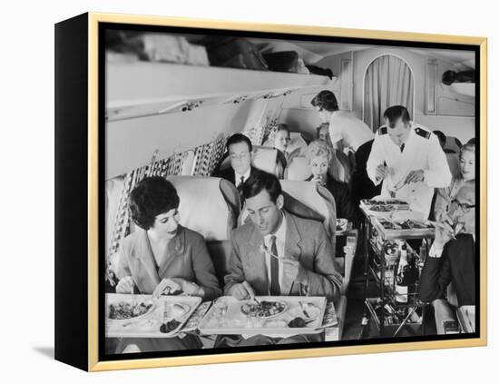 An Airline Steward and Air Hostess Serve a Roast Meal to Flight Passengers-null-Framed Premier Image Canvas