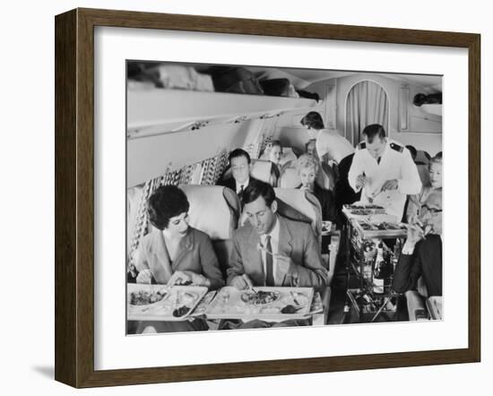 An Airline Steward and Air Hostess Serve a Roast Meal to Flight Passengers--Framed Photographic Print