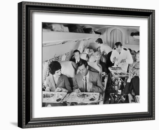 An Airline Steward and Air Hostess Serve a Roast Meal to Flight Passengers--Framed Photographic Print