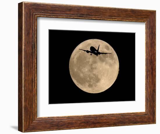 An Airliner is Silhouetted against a Full Moon-null-Framed Photographic Print