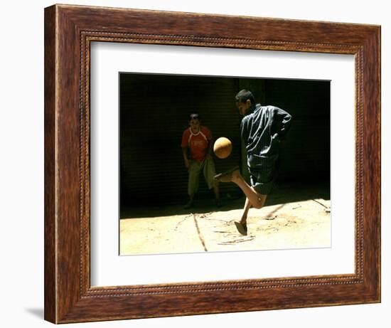 An Egyptian Boy Shows off His Ball Skill as He Plays Soccer with a Friend on the Steets of Cairo-null-Framed Photographic Print