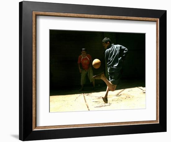 An Egyptian Boy Shows off His Ball Skill as He Plays Soccer with a Friend on the Steets of Cairo-null-Framed Photographic Print