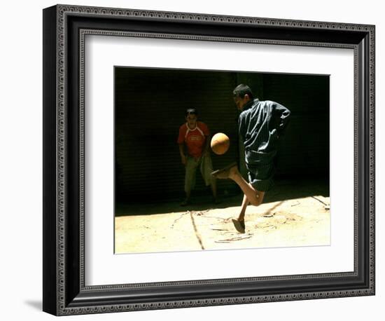 An Egyptian Boy Shows off His Ball Skill as He Plays Soccer with a Friend on the Steets of Cairo-null-Framed Photographic Print