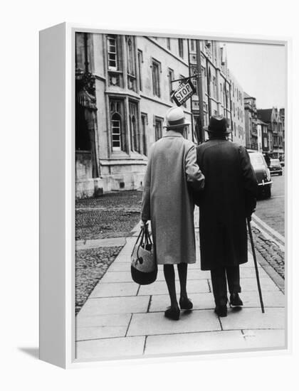 An Elderly Couple Walking Down the Street, Arm in Arm-Henry Grant-Framed Premier Image Canvas
