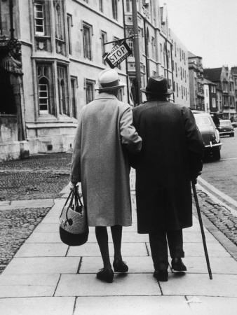 An Elderly Couple Walking Down The Street Arm In Arm Photographic Print Henry Grant Art Com