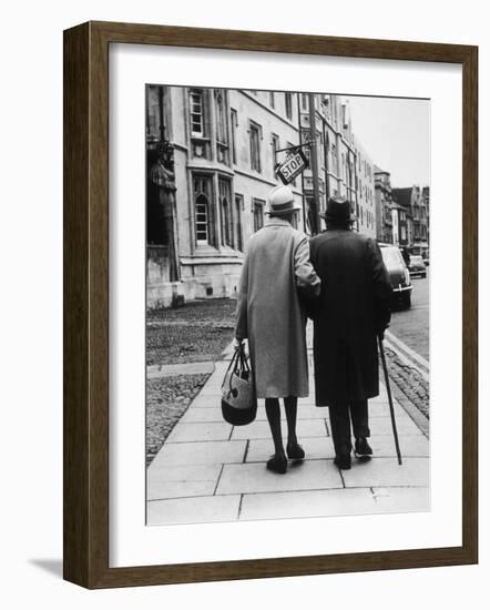 An Elderly Couple Walking Down the Street, Arm in Arm-Henry Grant-Framed Photographic Print