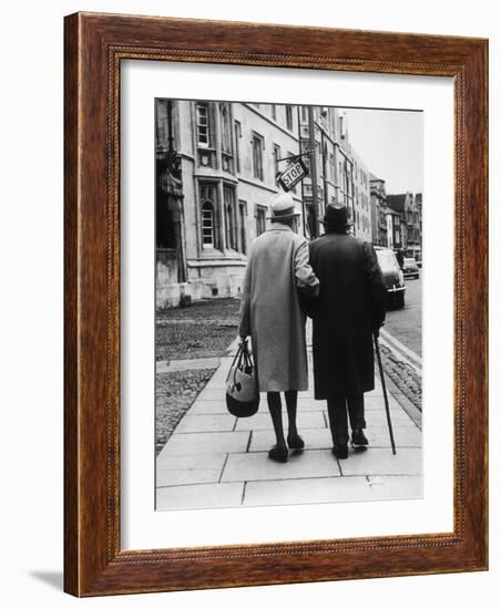 An Elderly Couple Walking Down the Street, Arm in Arm-Henry Grant-Framed Photographic Print