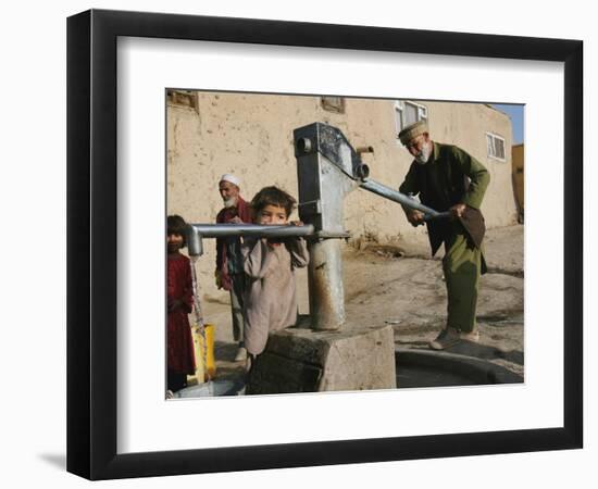 An Elderly Man Pumps Water from a Public Well in Kabul, Afghanistan, Friday, September 22, 2006-Rodrigo Abd-Framed Photographic Print