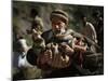 An Elderly Pakistani Earthquake Survivor Rushes Towards a Helicopter Carrying a Child in His Arms-null-Mounted Photographic Print