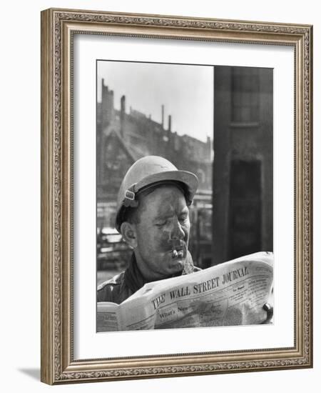 An Electrician Reads 'The Wall Street Journal' to Check His Stock Market Investments-null-Framed Photo