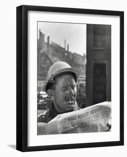 An Electrician Reads 'The Wall Street Journal' to Check His Stock Market Investments-null-Framed Photo