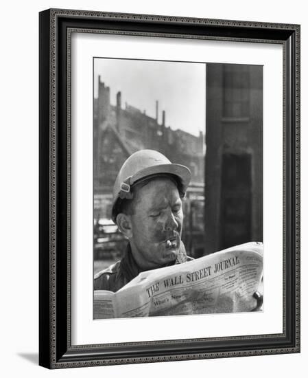 An Electrician Reads 'The Wall Street Journal' to Check His Stock Market Investments-null-Framed Photo