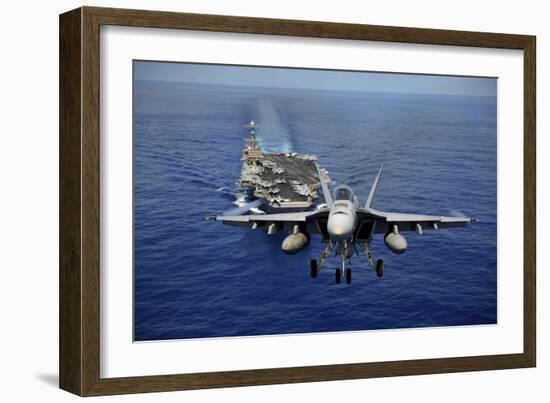 An F-A-18E Super Hornet Flying Above USS John C. Stennis-null-Framed Photographic Print