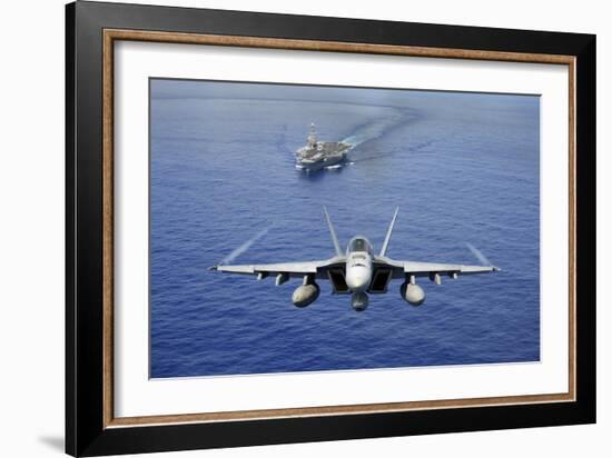 An F-A-18E Super Hornet Flying Above USS John C. Stennis-null-Framed Photographic Print